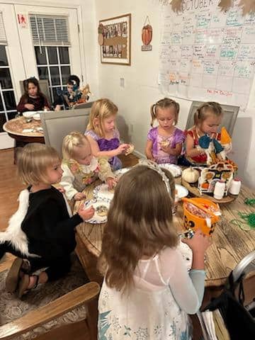 A group of children joyfully sitting around a table