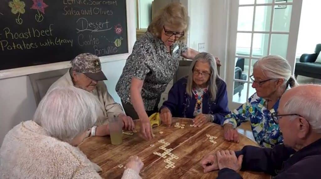 A group of elderly individuals engaged in a lively game of Scrabble